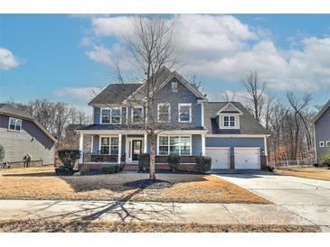 Charming two-story home with a welcoming front porch and a well-manicured lawn, perfect for suburban living at 1412 Great Rd, Waxhaw, NC 28174