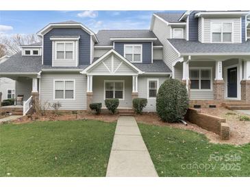 Charming townhome with a well-manicured lawn and inviting walkway at 14955 Alexander Place Dr, Huntersville, NC 28078