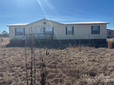 Single-wide mobile home with a brick skirting and deck at 169 Adams Cir, Candor, NC 27229