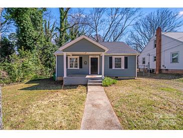 Charming home featuring a cute front porch, neat landscaping, and an inviting walkway at 3138 Morson St, Charlotte, NC 28208