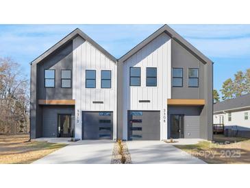 Modern townhomes featuring two-story design with individual garages and contrasting gray and white exteriors at 3308 Polk And White Rd, Charlotte, NC 28269