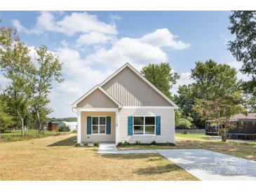 Charming single-story home with vinyl siding, blue shutters, and a well-manicured front yard at 338 Hudson St, Shelby, NC 28150