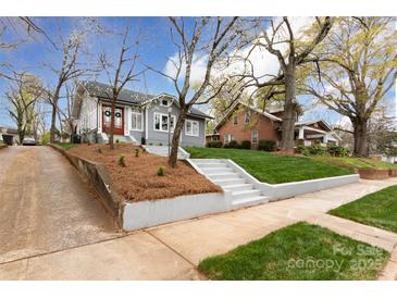 Gray craftsman home on a tree-lined street with a manicured lawn at 423 W Bell St, Statesville, NC 28677