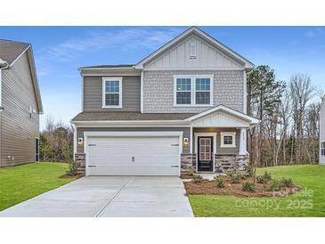 Two-story house with gray siding, white garage door, and landscaping at 4445 Dusty Orchard Rd, Kannapolis, NC 28081