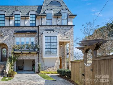 Brick front of charming townhome with driveway and landscaping at 633 Mattie Rose Ln, Charlotte, NC 28204