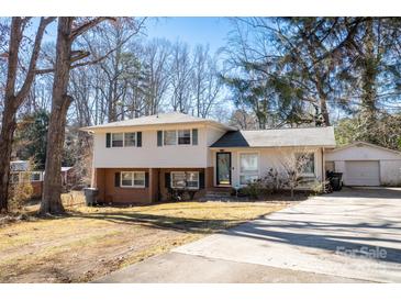 Ranch style home with a brick facade and attached garage at 7716 Elwood Dr, Charlotte, NC 28227