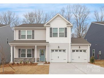 Charming two-story home with a two-car garage and a welcoming front porch at 213 Parkmont Dr # 137, Troutman, NC 28166