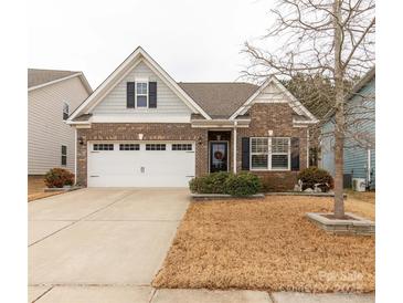 Charming brick home featuring a two-car garage and professionally landscaped front yard at 515 Stickley Pl, Lancaster, SC 29720