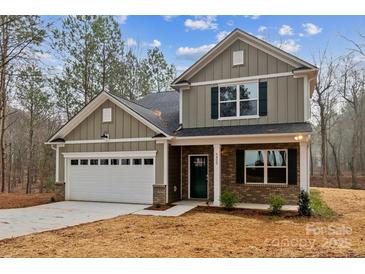 Two-story house with gray siding, white garage door, and a brick facade at 5422 Army Rd, Marshville, NC 28103