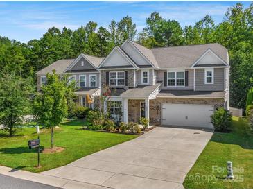 Two-story home with gray siding, two-car garage, and landscaped yard at 6029 Landry Ln, Indian Land, SC 29707