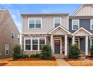 Charming two-story townhome with stone accents and a cozy front porch at 1201 Township Pkwy, Belmont, NC 28012