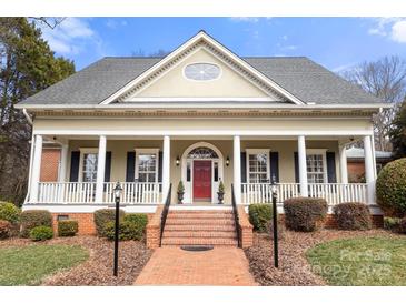 Charming home featuring a welcoming front porch with white columns and a bright red front door at 1335 E Marion St, Shelby, NC 28150