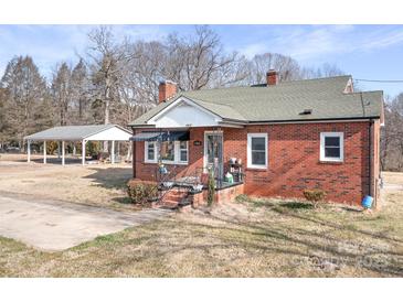 Exterior of a red brick home with a covered carport and well-kept lawn at 1902 Old Wilkesboro Rd, Statesville, NC 28625