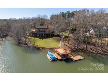 Stunning waterfront home featuring a private dock and lush landscaping at 2700 River Ridge Pl, Fort Mill, SC 29708