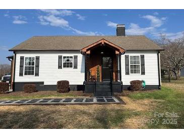 Home exterior featuring a covered porch and neatly graveled front yard at 3186 Catawba St, Claremont, NC 28610