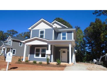 Charming two-story home showcasing a covered front porch, white trim, and a neatly landscaped yard at 601 Bentbrush Dr, Gastonia, NC 28056