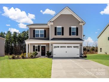 Two-story house with a beige exterior, white garage door, and landscaped lawn at 6351 Trinity Crossing Cir, Kannapolis, NC 28081