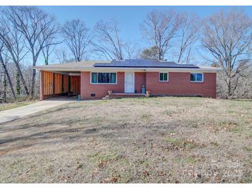 Brick ranch house with solar panels and carport at 720 Pleasant Ave, Kannapolis, NC 28081