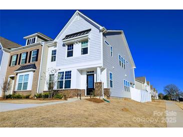 Charming two-story home with white siding, a brick foundation, and a well-maintained lawn at 12712 Wandering Brook Dr, Charlotte, NC 28273