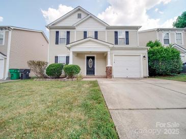Charming two-story home with a well-manicured lawn and inviting front entrance with a storm door at 13410 Tartarian Ct, Charlotte, NC 28215