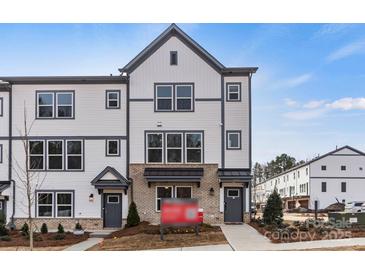 Modern three-story townhome with gray and white siding at 2320 Donnelly Hills Ln, Charlotte, NC 28262