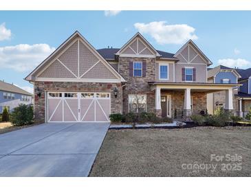 Charming two-story home with a brick and siding exterior, a two-car garage, and a well-manicured lawn at 4027 Wiltshire Ln, Indian Land, SC 29707