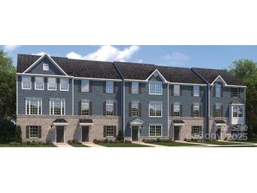 Charming new townhome features brick accents, complementary shutters, and covered entryway at 434 Serenity Cir # F, Cramerton, NC 28032