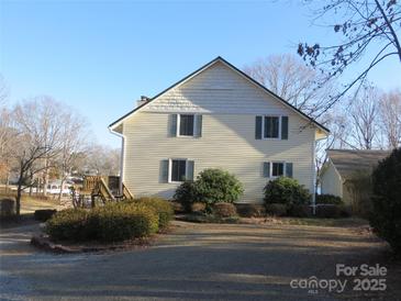 Two story home with neutral siding, green trim, and landscaping at 8188 Normandy Rd, Denver, NC 28037