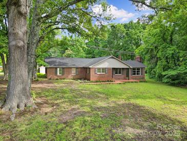 Charming brick ranch-style home with a well-maintained lawn and mature trees offering shade at 2988 Great Falls Hwy, Lancaster, SC 29720