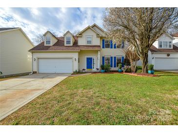 Charming two-story home featuring a well-manicured lawn and a welcoming blue front door and shutters at 5707 Brandy Ridge Ln, Charlotte, NC 28269