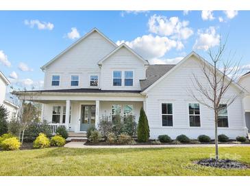 Two-story white farmhouse exterior with landscaping and large windows at 13109 Brooklyn Skylar Way, Huntersville, NC 28078