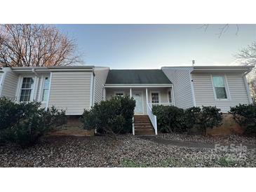 Charming home featuring a cozy front porch, a well-maintained lawn, and beautiful landscaping at 3331 Tamworth Ln, Gastonia, NC 28052