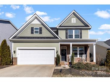 Charming two-story home with inviting brick-accented porch and well-maintained front yard at 4866 Breden St, Kannapolis, NC 28081