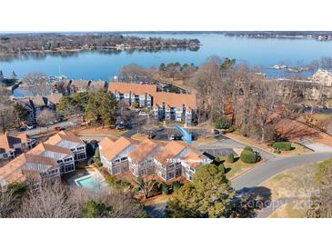 Stunning aerial view of lakeside condos, featuring beautiful lake views and community pool at 753 Southwest Dr, Davidson, NC 28036