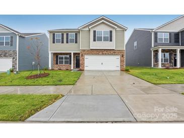 Charming two-story home with brick and siding, featuring a two-car garage and manicured lawn at 8032 Plymouth Dr, Sherrills Ford, NC 28673