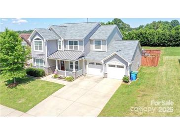 Charming two-story home with a two-car garage, covered porch, and well-maintained front yard at 1148 Mckee Farm Ln, Belmont, NC 28012