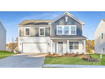 Two-story house with gray and white siding, a white garage door, and landscaping at 1715 Wooten Way, Bessemer City, NC 28016