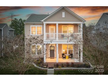 Charming two-story home with a welcoming front porch and second story balcony, perfect for enjoying the evening sunset at 375 Montibello Dr, Mooresville, NC 28117