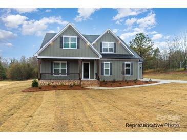 Charming two-story home with a covered front porch and beautifully landscaped front yard at 4021 Harmattan Dr, Denver, NC 28037