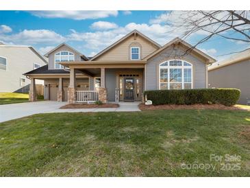 Charming two-story home with a welcoming front porch and well-maintained landscaping at 1137 Mckee Farm Ln, Belmont, NC 28012