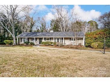 Ranch home with gray roof, landscaping, and a curved driveway at 170 Sherwood Cir, Rock Hill, SC 29730