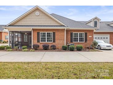 Charming brick home with well-manicured landscaping and inviting curb appeal at 2008 Surefire Ct, Denver, NC 28037
