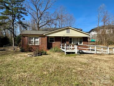 Charming single-story brick home featuring a wheelchair ramp in the front, offering easy access and accessibility at 3520 Carlyle Dr, Charlotte, NC 28208