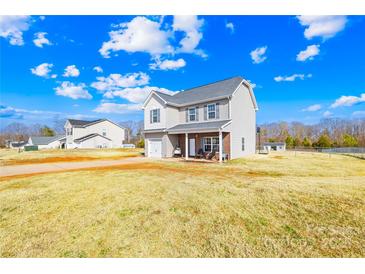 Charming two-story home with vinyl siding, attached garage, and landscaped yard under a sunny sky at 425 Webb Rd, Shelby, NC 28152