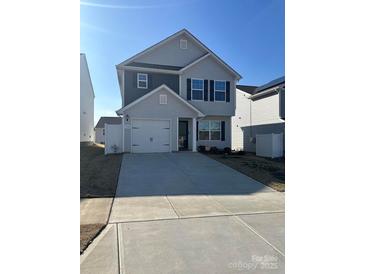 Charming two-story home with gray siding, attached garage, and a well-manicured front yard at 508 Hawley St, Charlotte, NC 28214