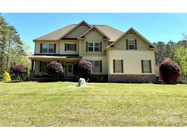 Charming two-story home with a well-manicured lawn and inviting front entrance at 712 Kenway Loop, Mooresville, NC 28117