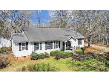 Charming single-story home with white siding and a well-manicured front yard at 7921 Fairmont Dr, Waxhaw, NC 28173