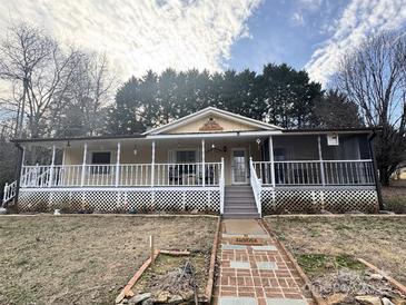 Ranch style home features a large front porch and landscaped yard at 92 Foot Hill Dr, Taylorsville, NC 28681