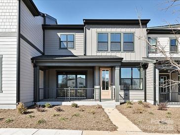 Two-story townhome with modern exterior, front porch, and landscaping at 95 Seven Oaks Lndg, Belmont, NC 28012