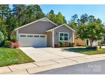 Charming single-story home featuring a well-manicured lawn and attached garage at 184 Flat Rock Dr, Denver, NC 28037